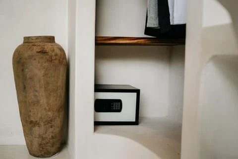 Hotel safe on a shelf with numeric keypad. Security safety money box on the.. Stock Photos