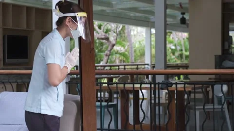 Hotel staff greets two cute sister kids wearing little bathrobes walking to spa Stock Footage 139048159