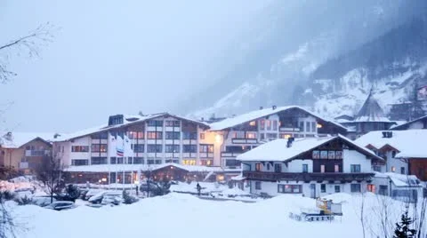 Hotel stands near road in valley where cars go and snow lies Stock Footage 12659904