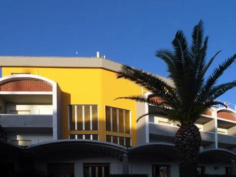 Hotel at sunset with palm tree Фото