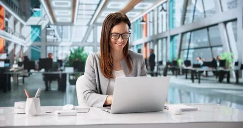 Hotel Supervisor Analyzing Guest Information On Laptop Amid Bustling Lobby En 写真素材