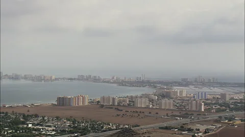 Hotels lined along coast and narrow stretch of land at Mar Menor Stock Footage 66824942
