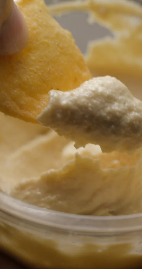 Houmous bread dipping close-up slow motion, vertical view Stock Footage 280520772