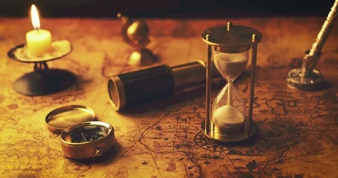 Hourglass and ancient navigation items on old world map Stock Footage 104089356