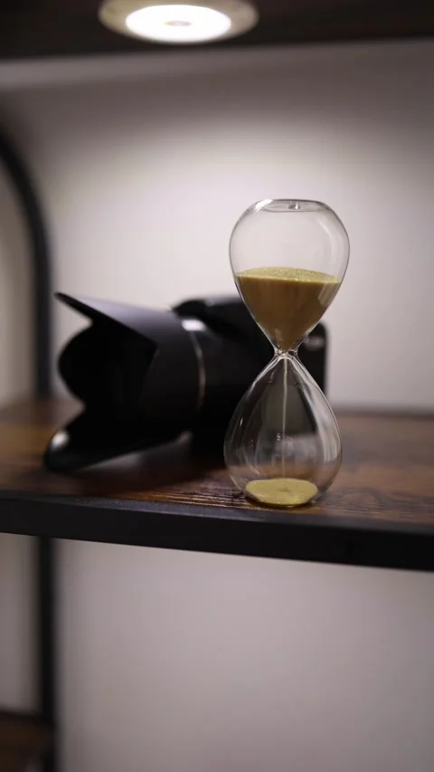 Hourglass and camera on shelf Stock Footage 336927546