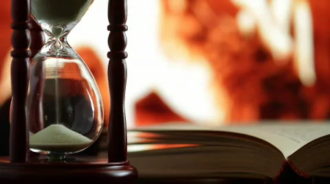 Hourglass and an open book. Stock Footage