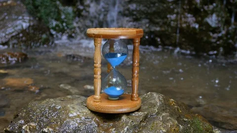 Hourglass on the Background of a Mountain River Vidéo 88982072