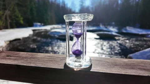 Hourglass on the background of the river. Slowmotion Stock-Footage 334059032