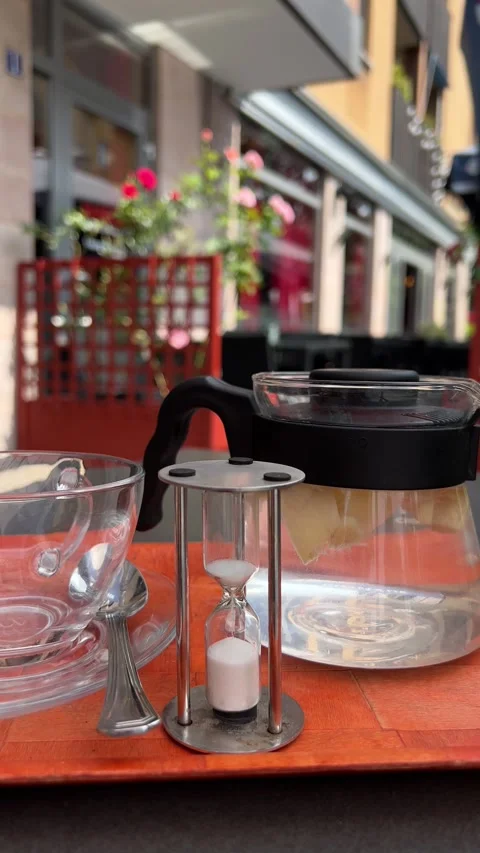 Hourglass being used for brewing tea in street cafe. Vertical video Stock Footage 246355834