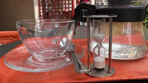 Hourglass being used for brewing tea in street cafe Stock Footage 246355907