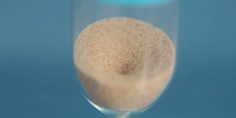 Hourglass on a blue background close-up. 스톡 동영상 74700888
