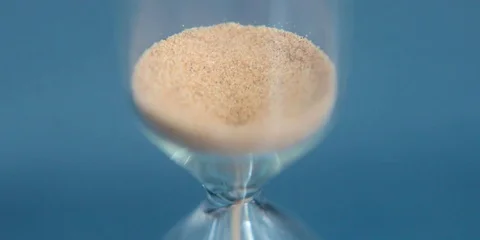 Hourglass on a blue background close-up. Stock Footage 74700908