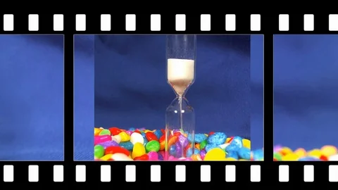 Hourglass on a Blue background, the sand falls inside. Stock Footage 88529997