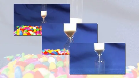 Hourglass on a Blue background, the sand falls inside. Stock Footage 88564306