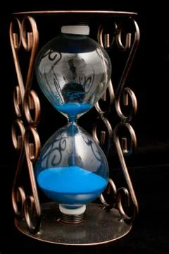Hourglass with blue sand Stock Photos