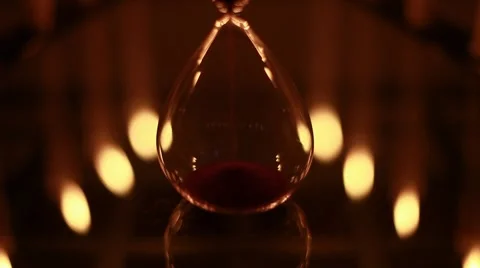 Hourglass with candles reflections Stock Footage 8683553