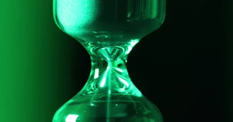 Hourglass closeup. video. Lighting changes - red, green, blue. sandglass Stock Footage 140964380