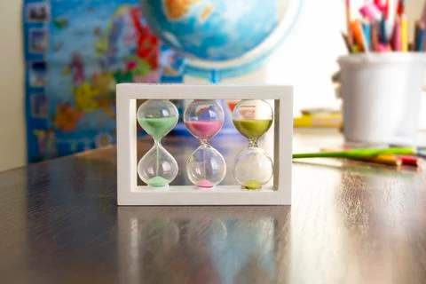Hourglass with colored sand Stock Photos