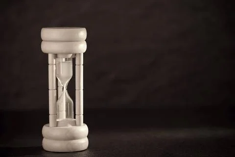 Hourglass on dark background. Time concept Stockfoto's