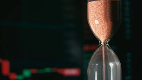 Hourglass is Falling on Background of a Crypto Exchange Close-up Stock Footage 233375710