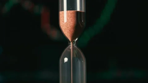 Hourglass is Falling on Background of a Crypto Exchange Close-up Stock Footage 233831684