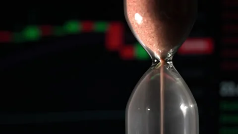 Hourglass is Falling on Background of a Crypto Exchange Close-up Stock Footage 236115732