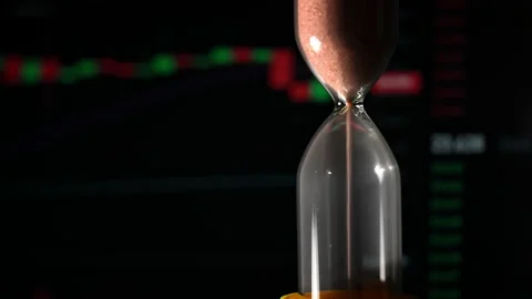 Hourglass is Falling on Background of a Crypto Exchange Close-up Stock Footage 236422770