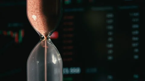 Hourglass is Falling on Background of a Crypto Exchange Close-up Stock Footage 236933989