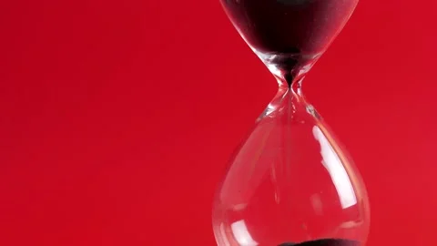 Hourglass flow on red background 4k Stock Footage 139890281