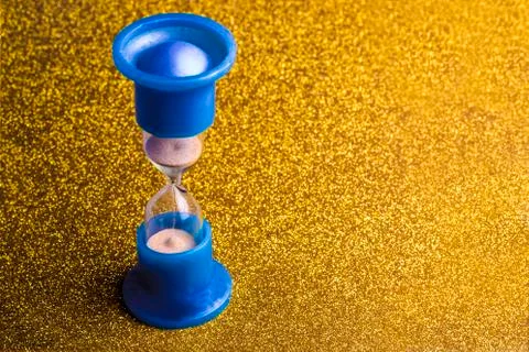 Hourglass on glitter Stock Photos