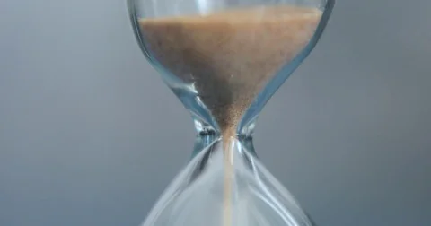 Hourglass on a gray background close-up. Stock Footage 74700867