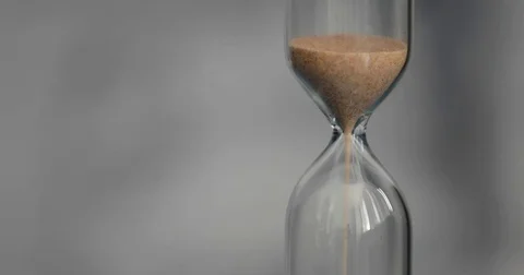 Hourglass on a gray background. Stock Footage 74700841