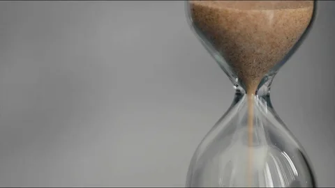 Hourglass on a gray background. Stock Footage 74700929