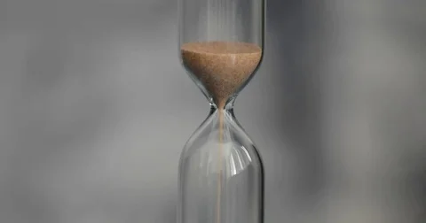Hourglass on a gray background. Stock Footage