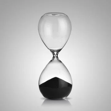 Hourglass on gray background Stock Photos