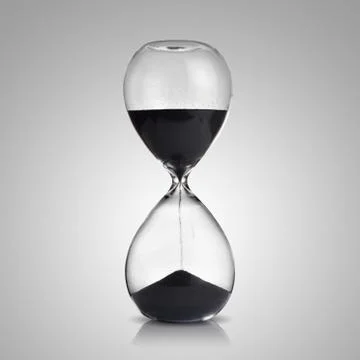 Hourglass on gray background Stock Photos