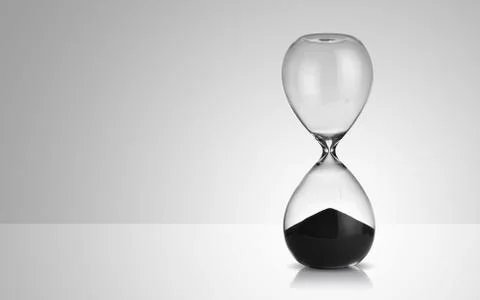 Hourglass on gray background Stock Photos