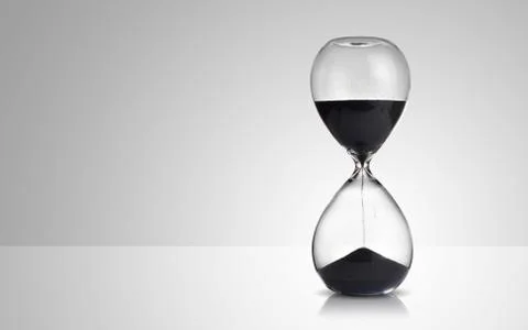 Hourglass on gray background Stock Photos
