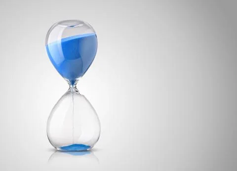 Hourglass on gray background Stock Photos