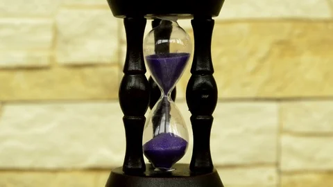 Hourglass with lilac sand Stock Footage 94609574