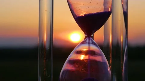 Hourglass macro on the background of the setting sun Stock Footage 155592367