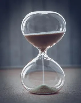 Hourglass measuring the passing time in a countdown to a deadline, on a blur Foto stock