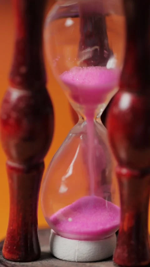 Hourglass with Pink Sand Falling, Time Flow Concept, Macro Shot, Vertical Stock Footage 308787991