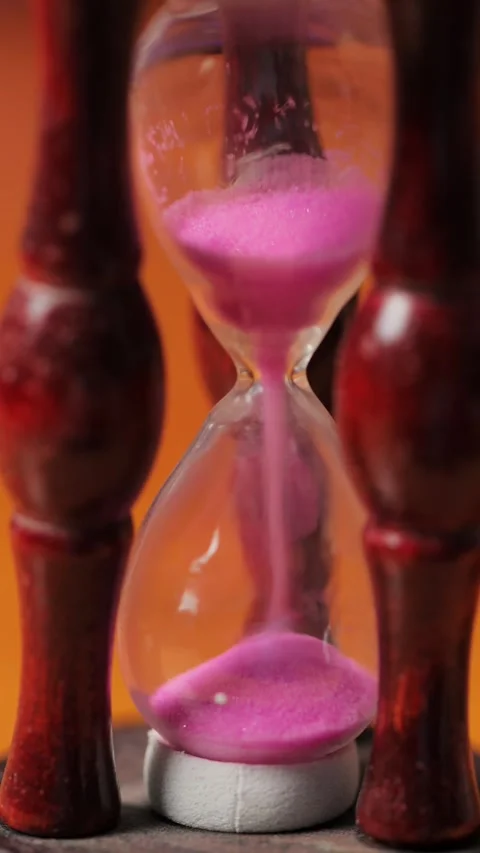 Hourglass with Pink Sand Falling, Time Flow Concept, Macro Shot, Vertical Stock Footage 308787998