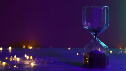 Hourglass on purple background with backlighting Stock Footage 286948726