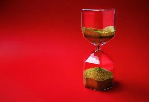 Hourglass on red Stock Photos