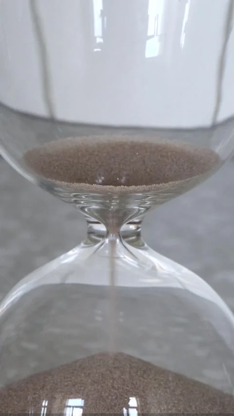 Hourglass with sand completely emptied on light background Stock Footage 335781140