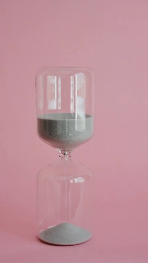 Hourglass with sand dropping through, vertical Stock Footage 92879171