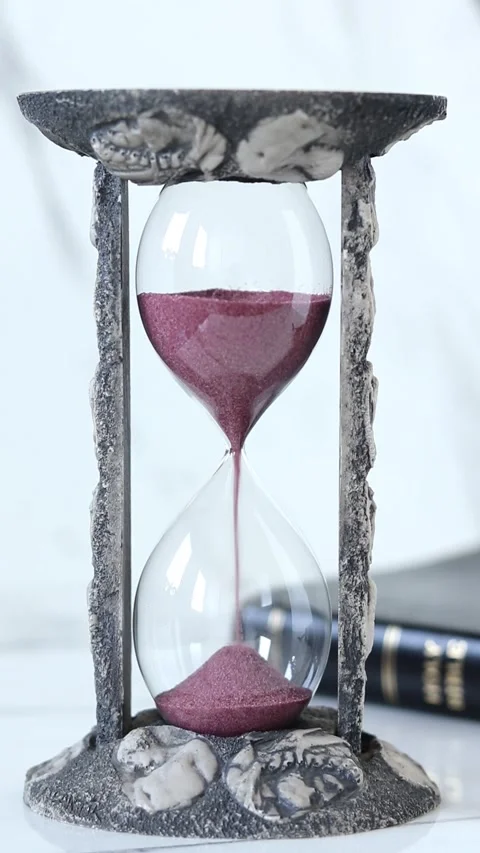 Hourglass with sand falling and holy bible on white marble background Stock Footage 294596328