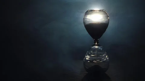 Hourglass sand timer counting down time with dramatic lighting and smoke ef.. Stock Footage 334832442
